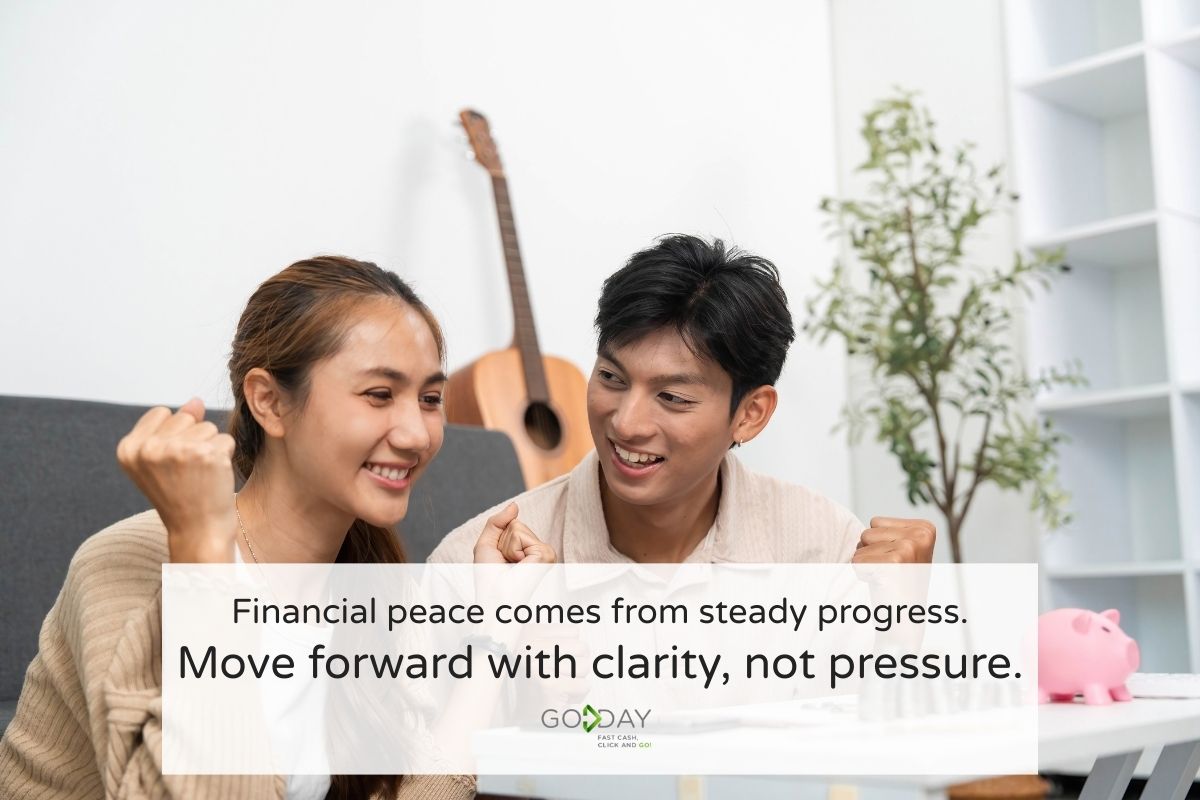Smiling couple celebrating financial progress together at home, representing clarity and stress-free money habits