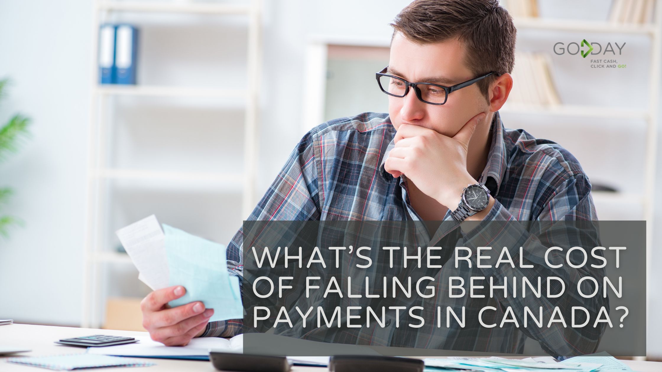 Concerned man reviewing bills at a desk, highlighting the financial impact of falling behind on payments in Canada.