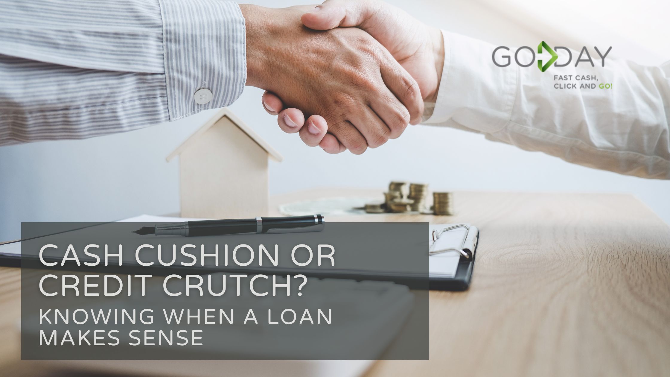 Two people shaking hands over a financial agreement with coins, clipboard, and house model on table, promoting GoDay's loan advice.
