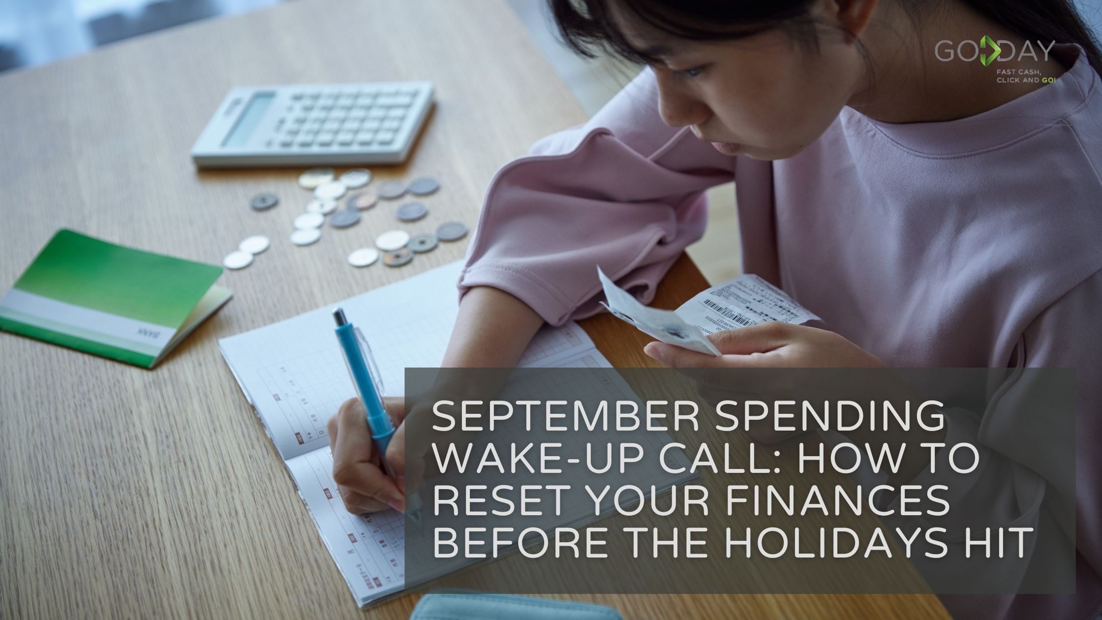 A young woman reviews receipts and tracks expenses in a budget planner with coins and a calculator on the table — promoting financial awareness and smart September spending with GoDay.