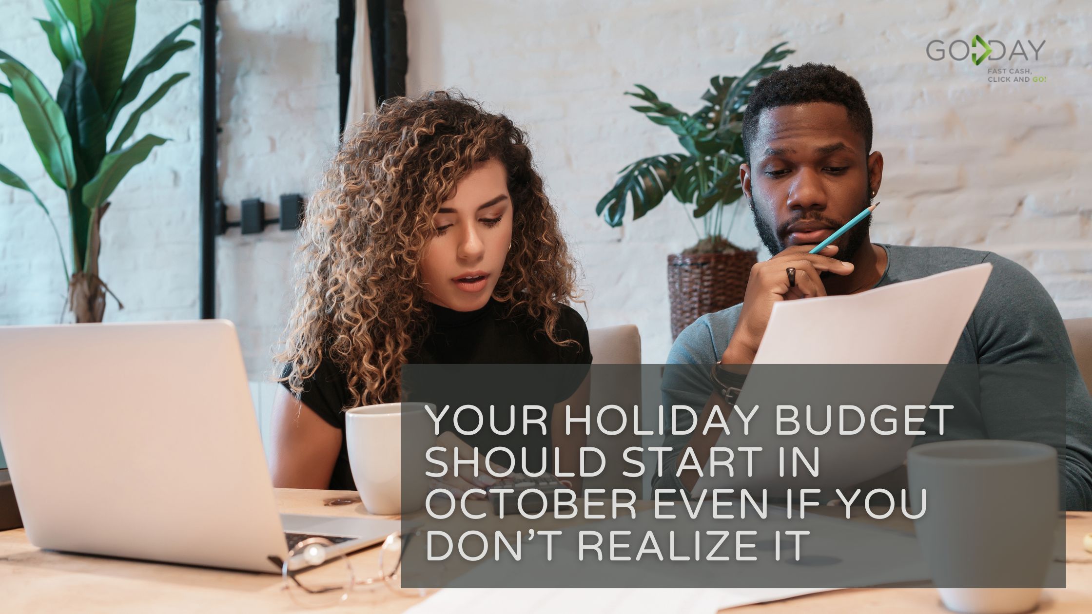 Couple reviewing holiday expenses at a laptop, emphasizing the importance of starting a holiday budget in October to stay financially prepared and stress-free.