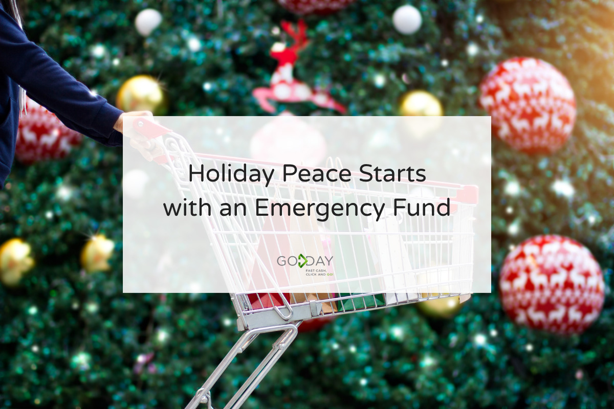 A person pushes an empty shopping cart in front of a Christmas tree decorated with ornaments, promoting the importance of building a holiday emergency fund.